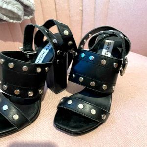 Black, leather Steve Madden sandals; chunky heels; silver brads, ankle straps.